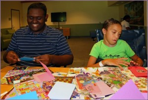 Two children at Shriner's making cards with Hui Malama Po`o