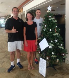 Photo of Brian, Kathleen, and Christopher in front of tree