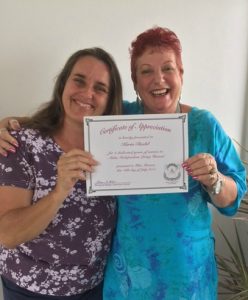 Photo of Karin and Sam holding Karin's 2nd anniversary certificate