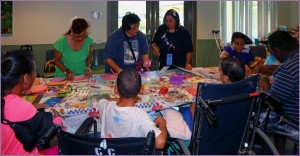 Hui Malama Po`o Shriner's Service Project. Photo of  children learning how to make cards.