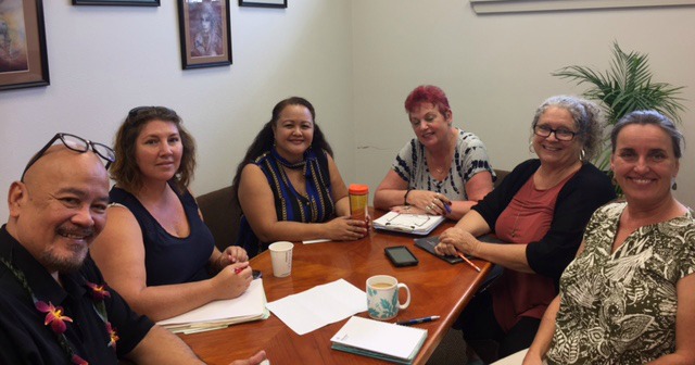 Photo of Hilo staff sitting conference table