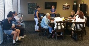 Photo of people gathering around a conference table