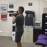 Photo of Ray filming in the AILH Oahu office