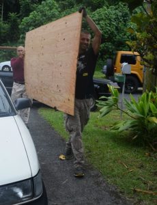 Photo of men moving plywood