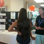 Photo of Kathleen speaking with woman at Kalama Heights Health Fair