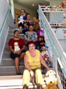 Photo of AILH staff and volunteers with stuffed animals