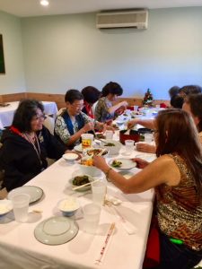 Photo of Hui Members talking around table