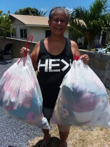 Photo of woman holding two bags full of stuffed animals