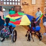 Photo of Hilo youth support group members playing with parachute