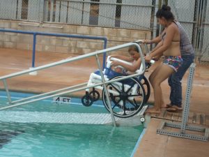 Photo of Felix's mom and sister taking him out of pool