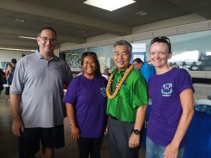Photo of Brian, Lani, and Kathleen with Governor Ige