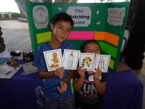 Photo of two keiki holding matching cards