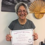 Photo of Pomai holding certificate