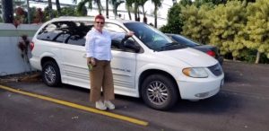 Photo of Sam standing next to donated van